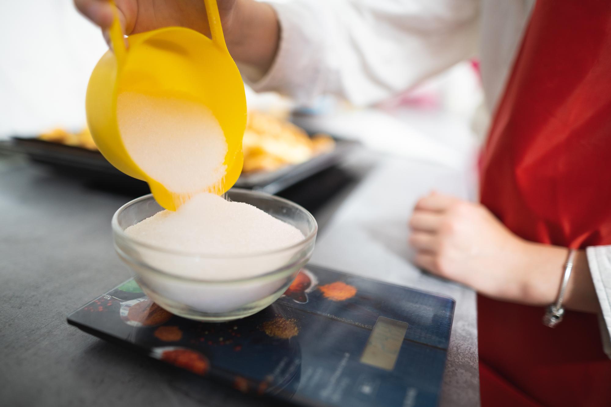 Instructor guiding student on sauce viscosity